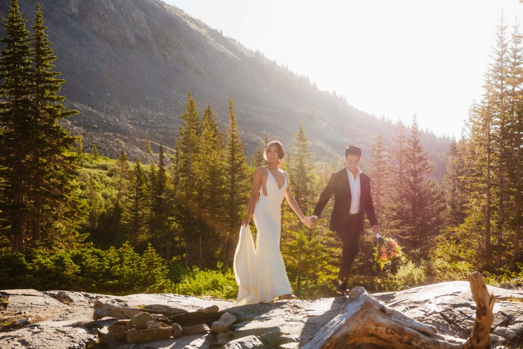 a couple holds hands while walking in the mountains during their elopement Breckenridge, Colorado Elopement