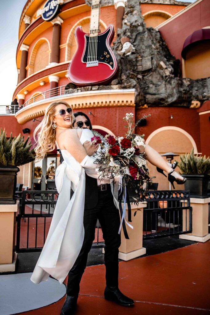 a man carries his bride away from the hardrock hotel during their elopement in Orlando