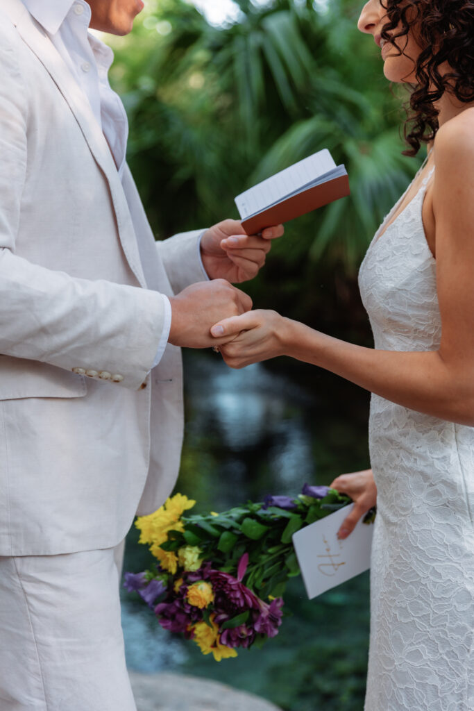 a couple holds hands as they read their vows in kelly rock springs elopement in Florida - how to elope in florida