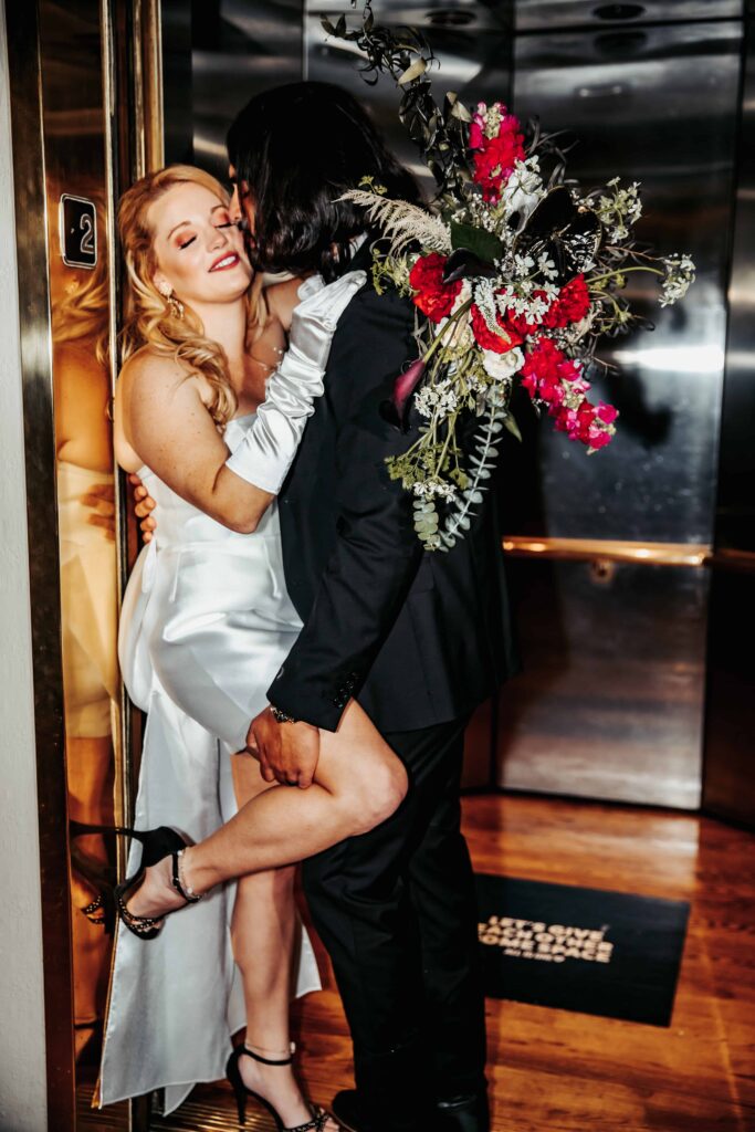 a couple kisses in an elevator during their elopement