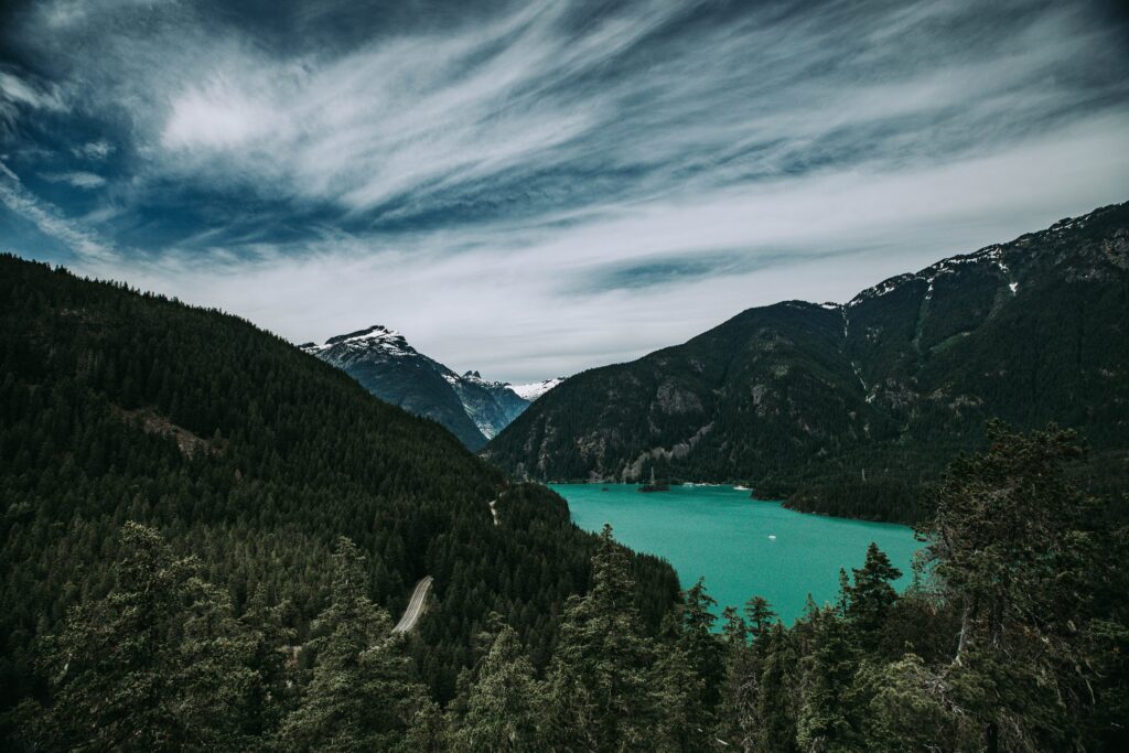 Turquoise alpine lake surrounded by rugged peaks in North Cascades National Park, a stunning national park to elope for adventurous couples seeking remote beauty.
