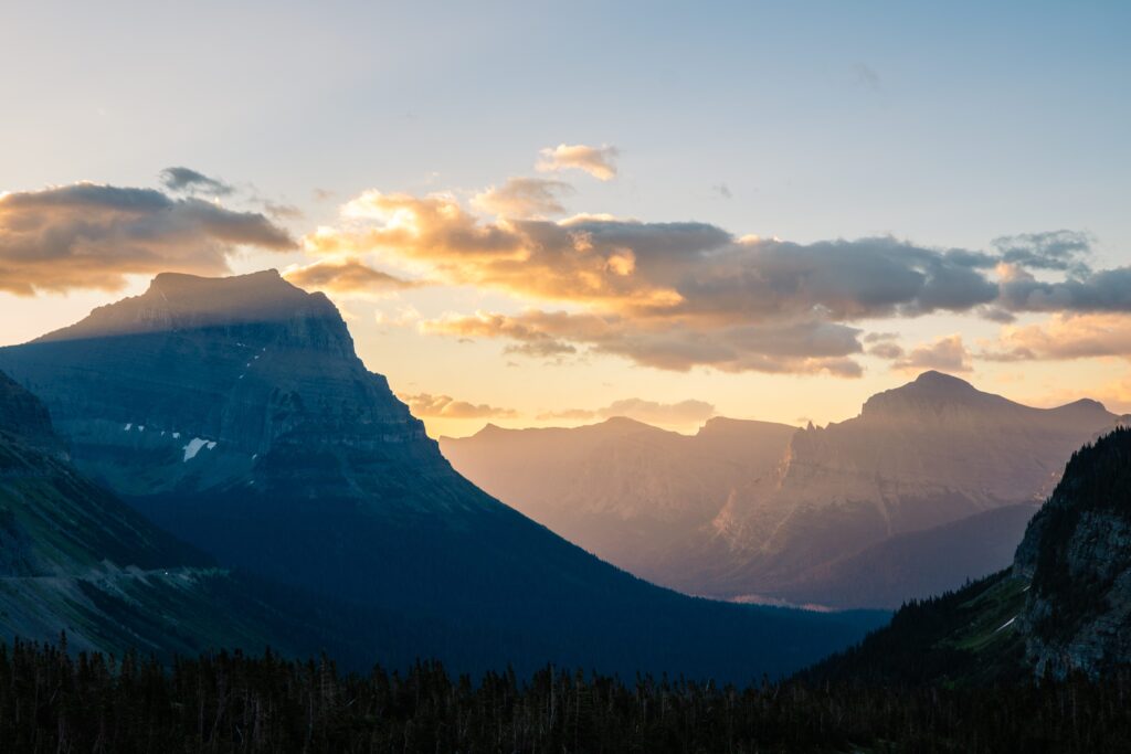 Sunset over the rugged peaks of Glacier National Park, a breathtaking national park to elope for couples seeking alpine beauty and mountain adventure.