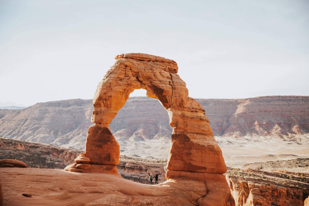 Delicate Arch glowing in the desert sun at Arches National Park, a spectacular national park to elope for couples who love red rock landscapes and adventure.